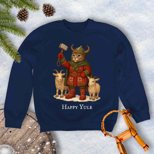 Navy sweatshirt with a aesir Thor reimagined Viking cat design and two goats. 'Happy Yule' text on a snowy background.