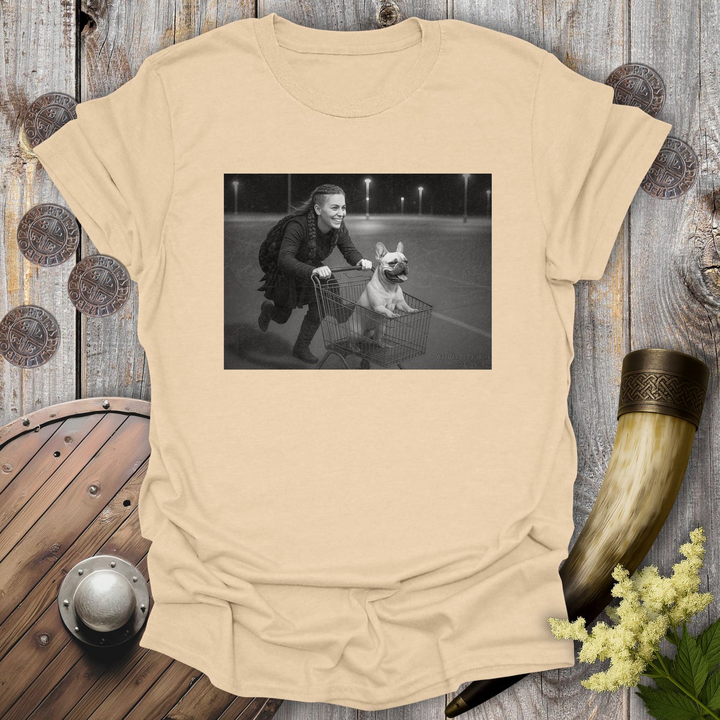 Navy Blue t-shirt with a graphic of a Viking Shieldmaiden and a Bulldog in a shopping cart, sprinting on a parking Lot.