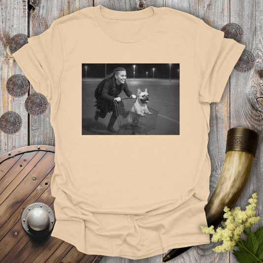 Navy Blue t-shirt with a graphic of a Viking Shieldmaiden and a Bulldog in a shopping cart, sprinting on a parking Lot.