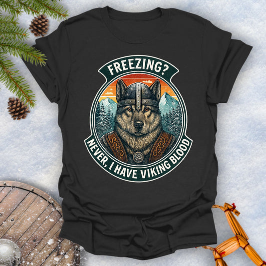 Black t-shirt with a graphic of a Viking Norwegian Elkhound and text 'Freezing? Never, I have Viking blood' with a Nordic, retro sunset graphic in the background.
