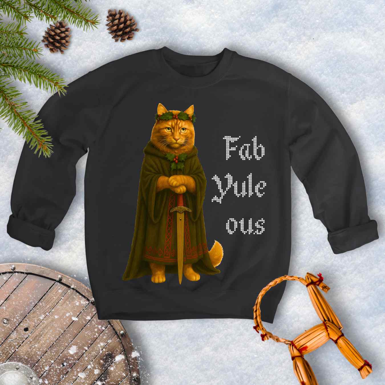 Black sweatshirt with a Shieldmaiden cat in a cloak and sword graphic and 'Fab Yule ous' cross stich lookalike text.