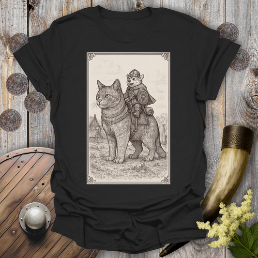 Black t-shirt with a beige and black graphic of a large cat and a Corgi Viking Dog riding it, in a Medieval Viking Age setting.