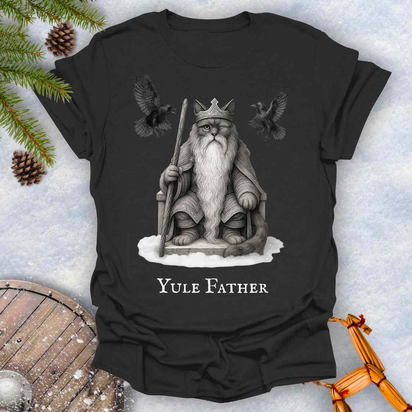 Black T-shirt with the aesir Odin reimagined as a black cat. Text 'Yule Father' design on a snowy background.