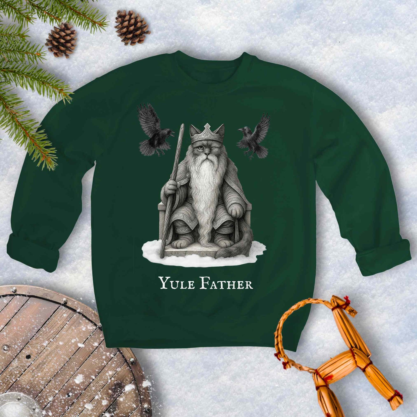 Green sweatshirt with the aesir Odin reimagined as a black cat. Text 'Yule Father' design on a snowy background.