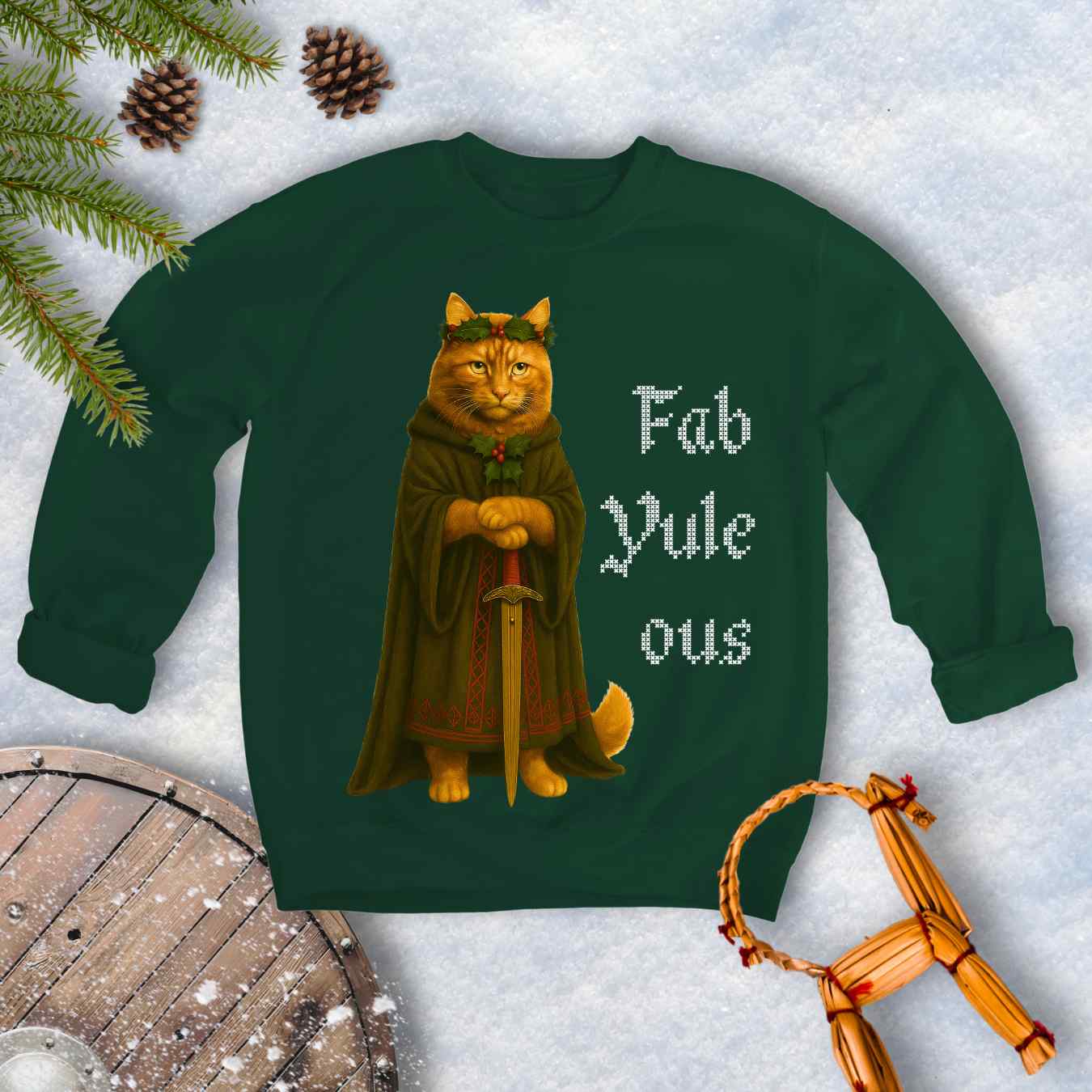 Forest Green sweatshirt with a Shieldmaiden cat in a cloak and sword graphic and 'Fab Yule ous' cross stich lookalike text.
