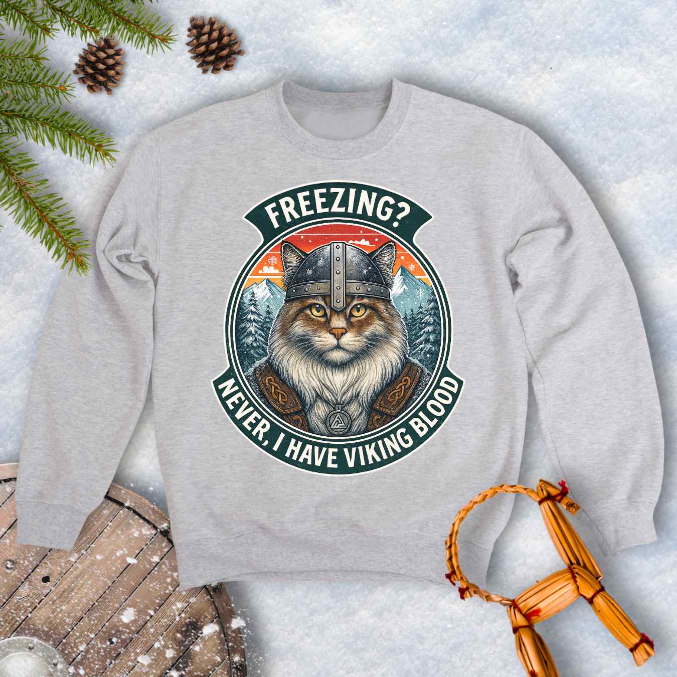 Gray Ash colored sweatshirt with a graphic of a Viking Norwegian Forest Cat and text 'Freezing? Never, I have Viking blood' with a Nordic, retro sunset graphic in the background.