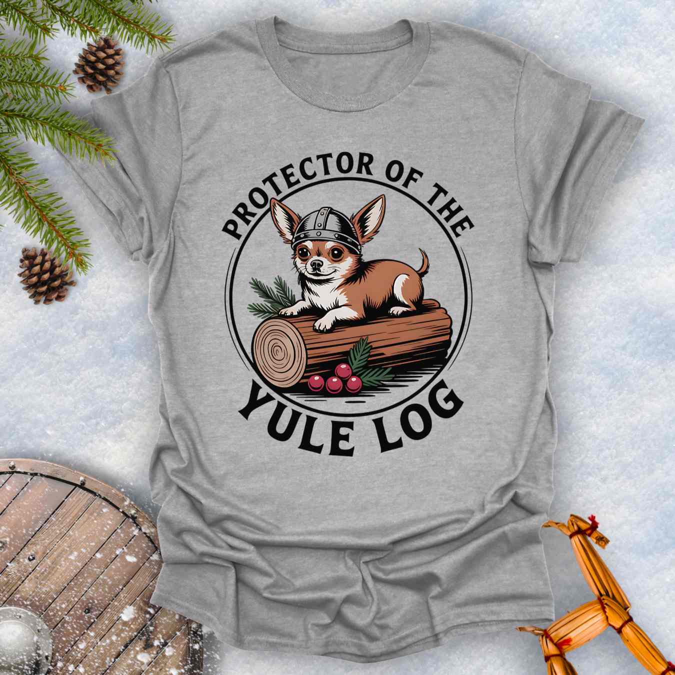 Gray t-shirt with a Chihuahua Viking dog graphic and 'Protector of the Yule Log' text on a snowy background.