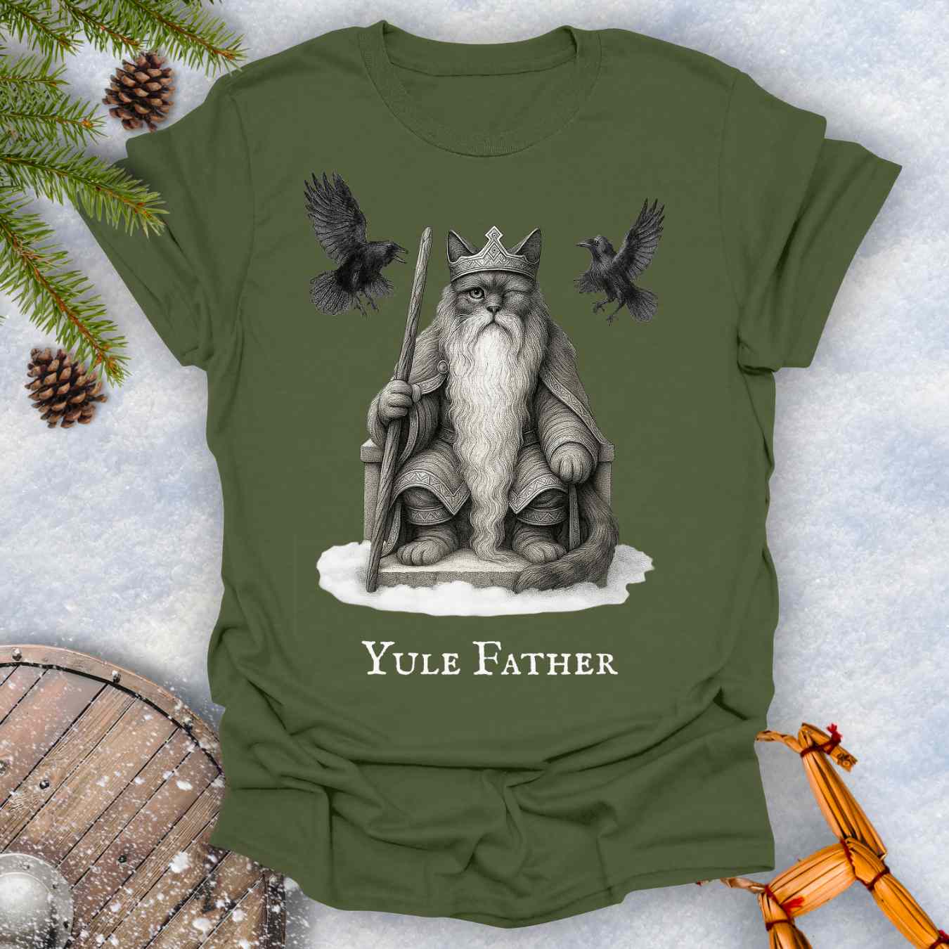 Green T-shirt with the aesir Odin reimagined as a black cat. Text 'Yule Father' design on a snowy background.
