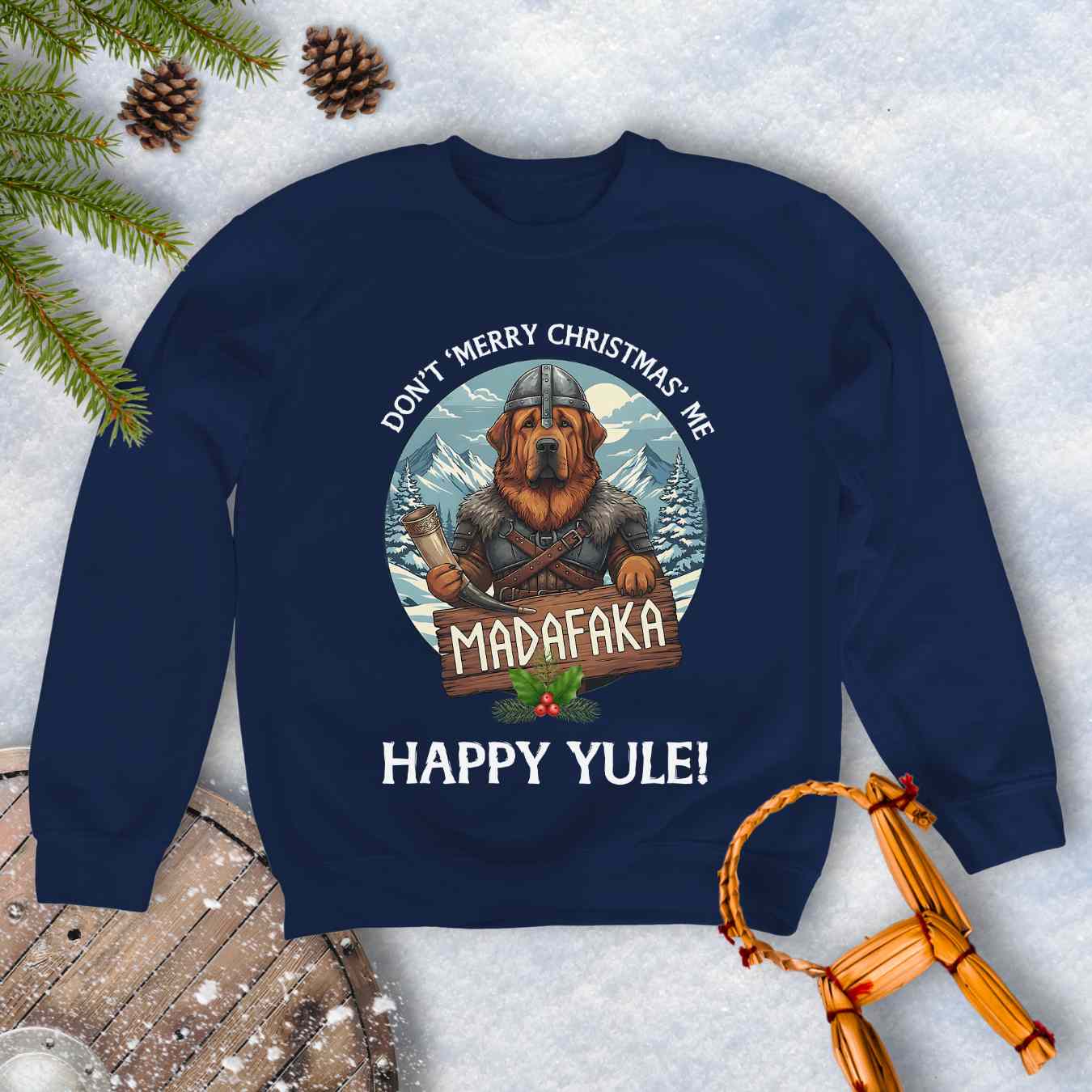 Navy Blue sweatshirt with a Viking Tibetan Mastiff holding a sign that says MADAFAKA. Also text: Don´t Merry Christmas Me, Happy Yule! Snowy Mountains and trees in the background.