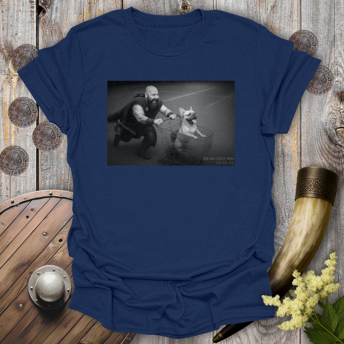 Navy Blue t-shirt with a graphic of a Viking and a Bulldog in a shopping cart, sprinting on a parking Lot.