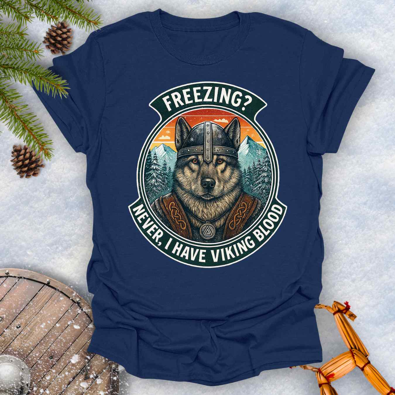 Navy blue t-shirt with a graphic of a Viking Norwegian Elkhound and text 'Freezing? Never, I have Viking blood' with a Nordic, retro sunset graphic in the background.