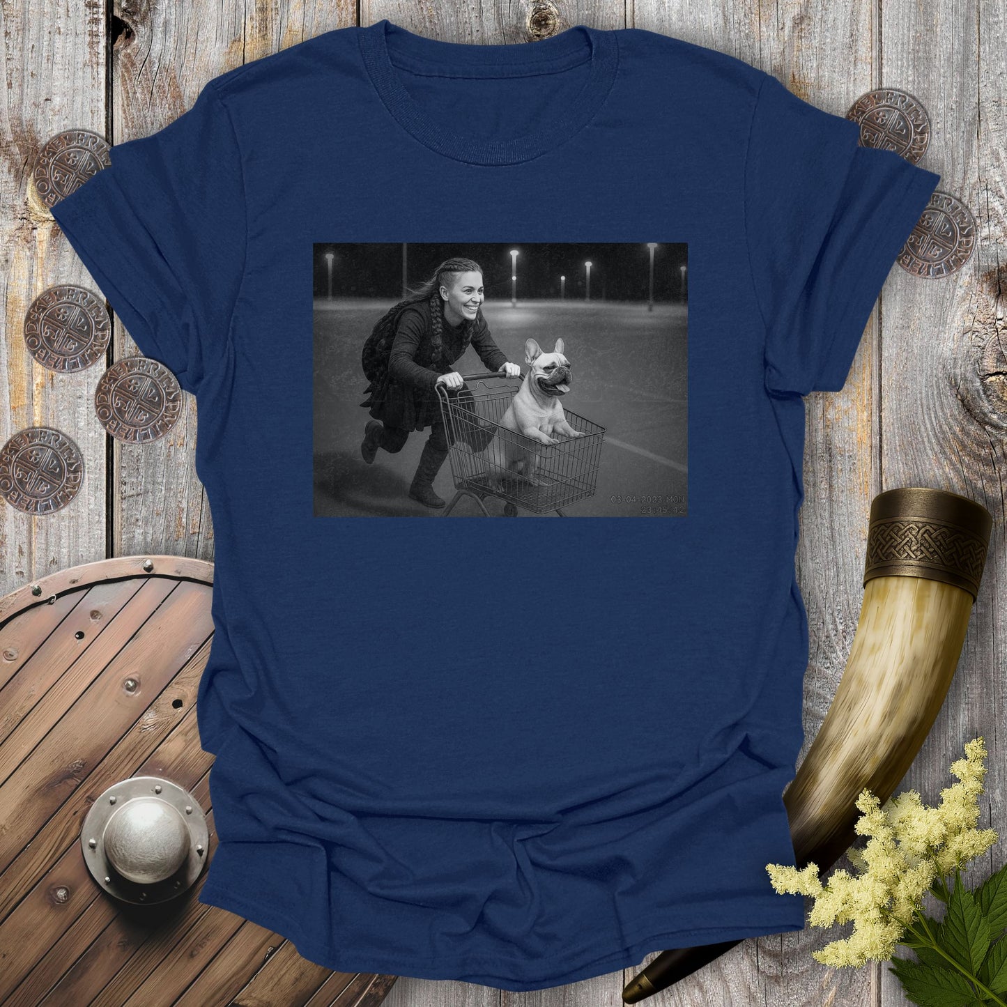 Navy Blue t-shirt with a graphic of a Viking Shieldmaiden and a Bulldog in a shopping cart, sprinting on a parking Lot.