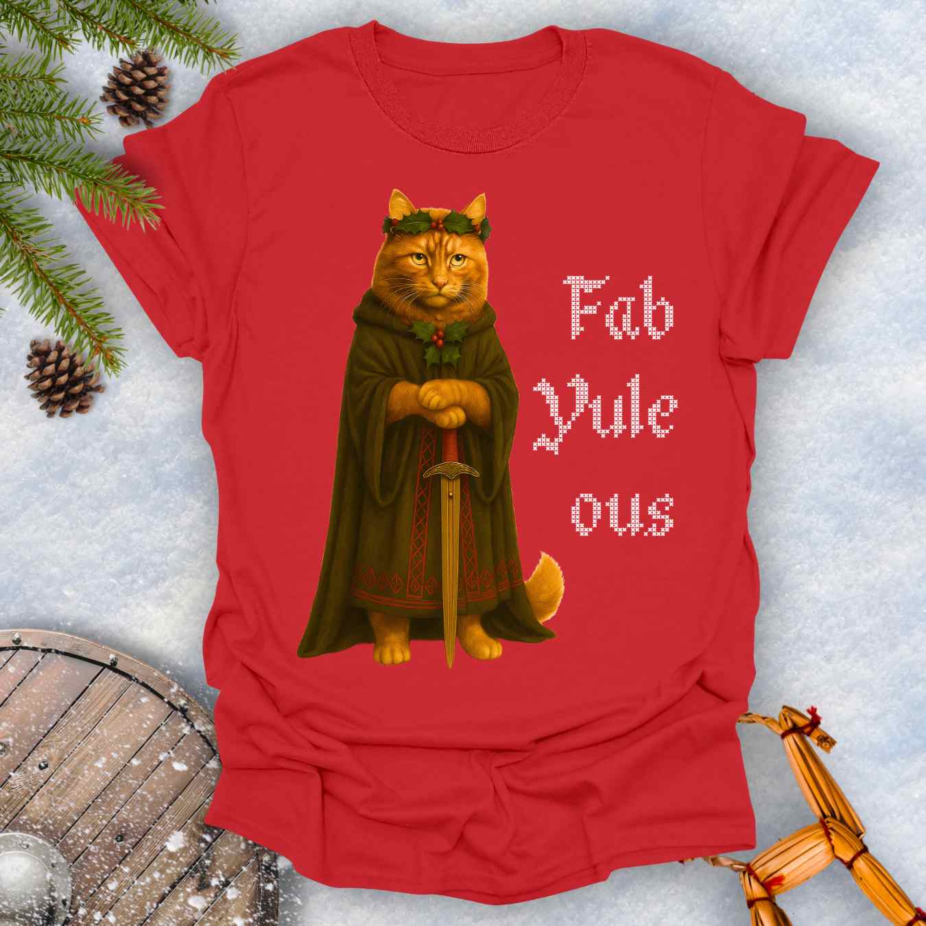 Red t-shirt with a Shieldmaiden cat in a cloak and sword graphic and 'Fab Yule ous' cross stich lookalike text.