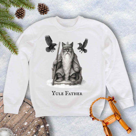 White sweatshirt with the aesir Odin reimagined as a black cat. Text 'Yule Father' design on a snowy background.