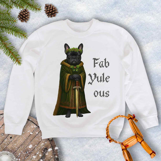 White sweatshirt with a black shieldmaiden Bulldog in a green robe and sword, surrounded by Christmas decorations and vertical text 'Fab Yule ous'.