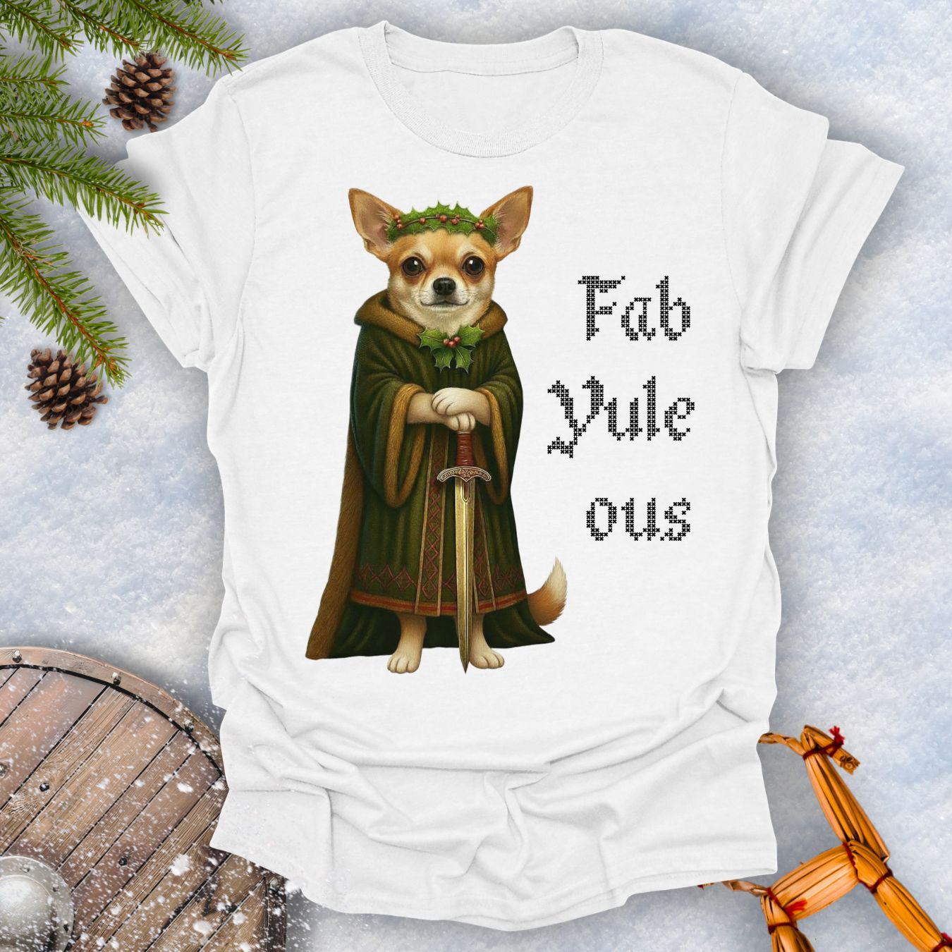 White t-shirt with a Viking Chihuahua dog in a robe and sword graphic and 'Fab Yule ous' text, surrounded by Christmas decorations.