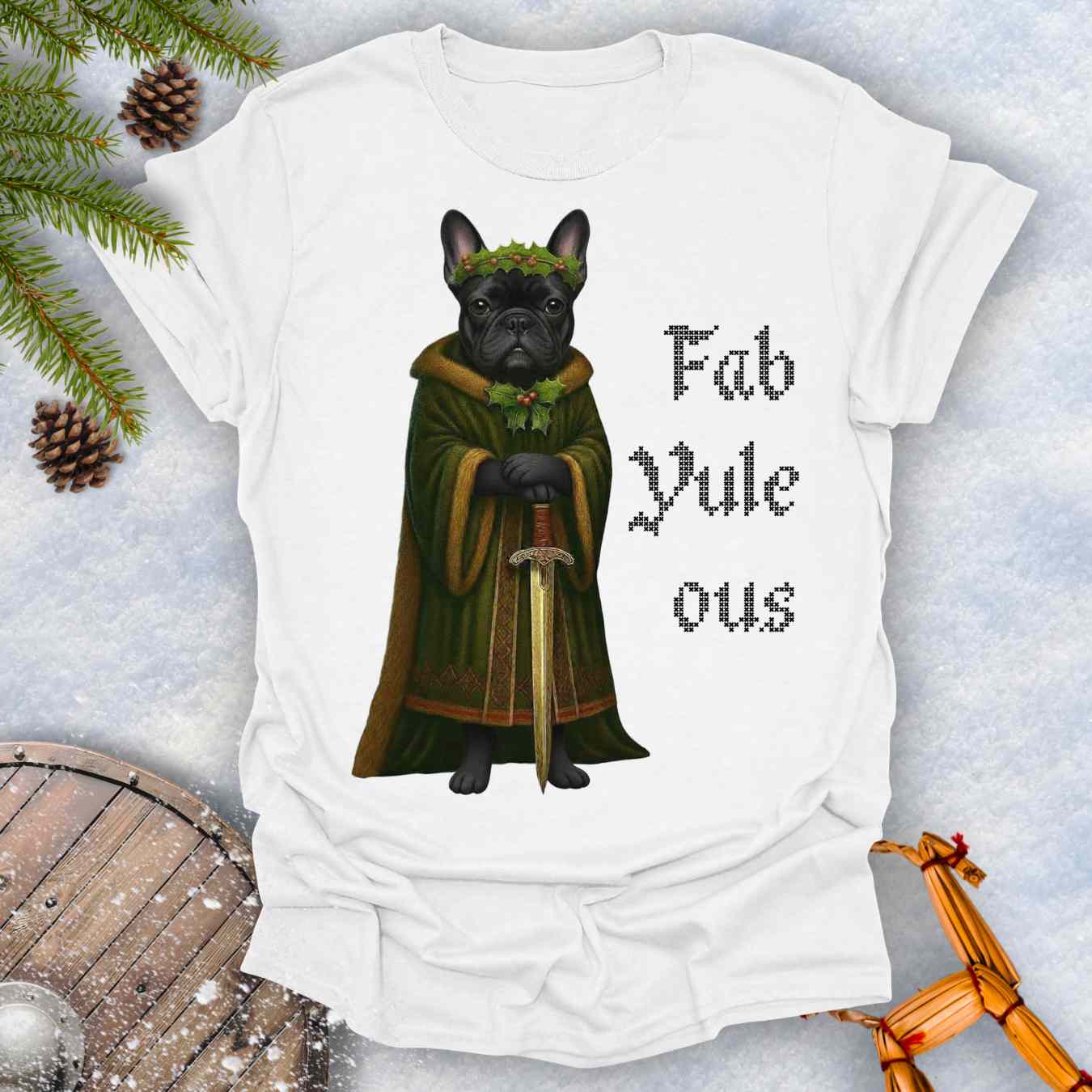 White t-shirt with a black shieldmaiden Bulldog in a green robe and sword, surrounded by Christmas decorations and vertical text 'Fab Yule ous'.