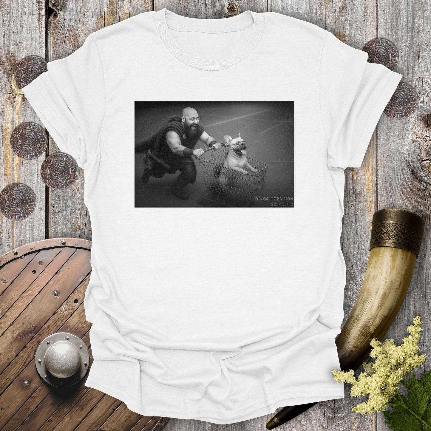 White t-shirt with a graphic of a Viking and a Bulldog in a shopping cart, sprinting on a parking Lot.