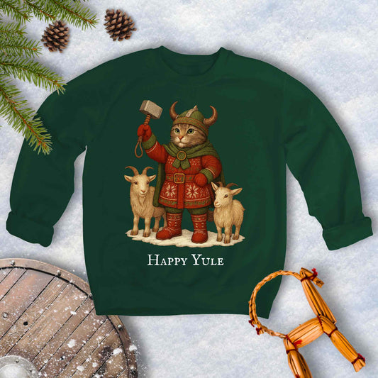Green sweatshirt with a aesir Thor reimagined Viking cat design and two goats. 'Happy Yule' text on a snowy background.