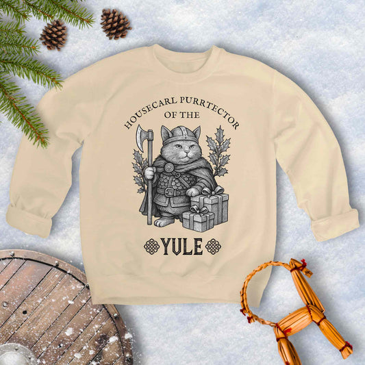 Beige Sand colored sweatshirt with a cat in a Viking outfit and Christmas gifts with 'Housecat Purrtector of the Yule' text. 