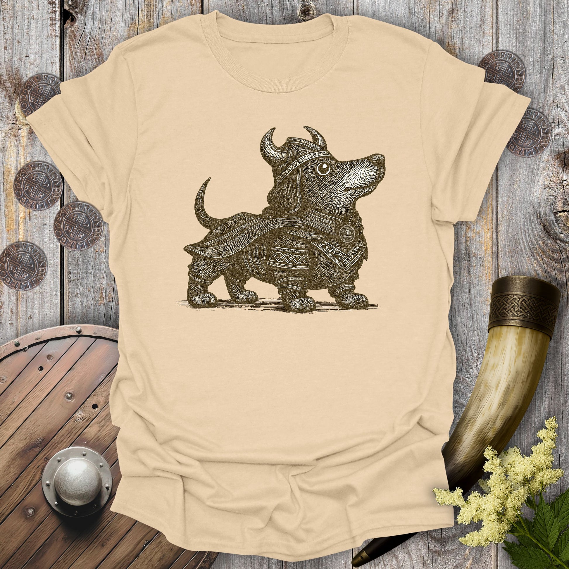 Beige Sand colored t-shirt with a Viking-themed dachshund brown graphic on a wooden background.