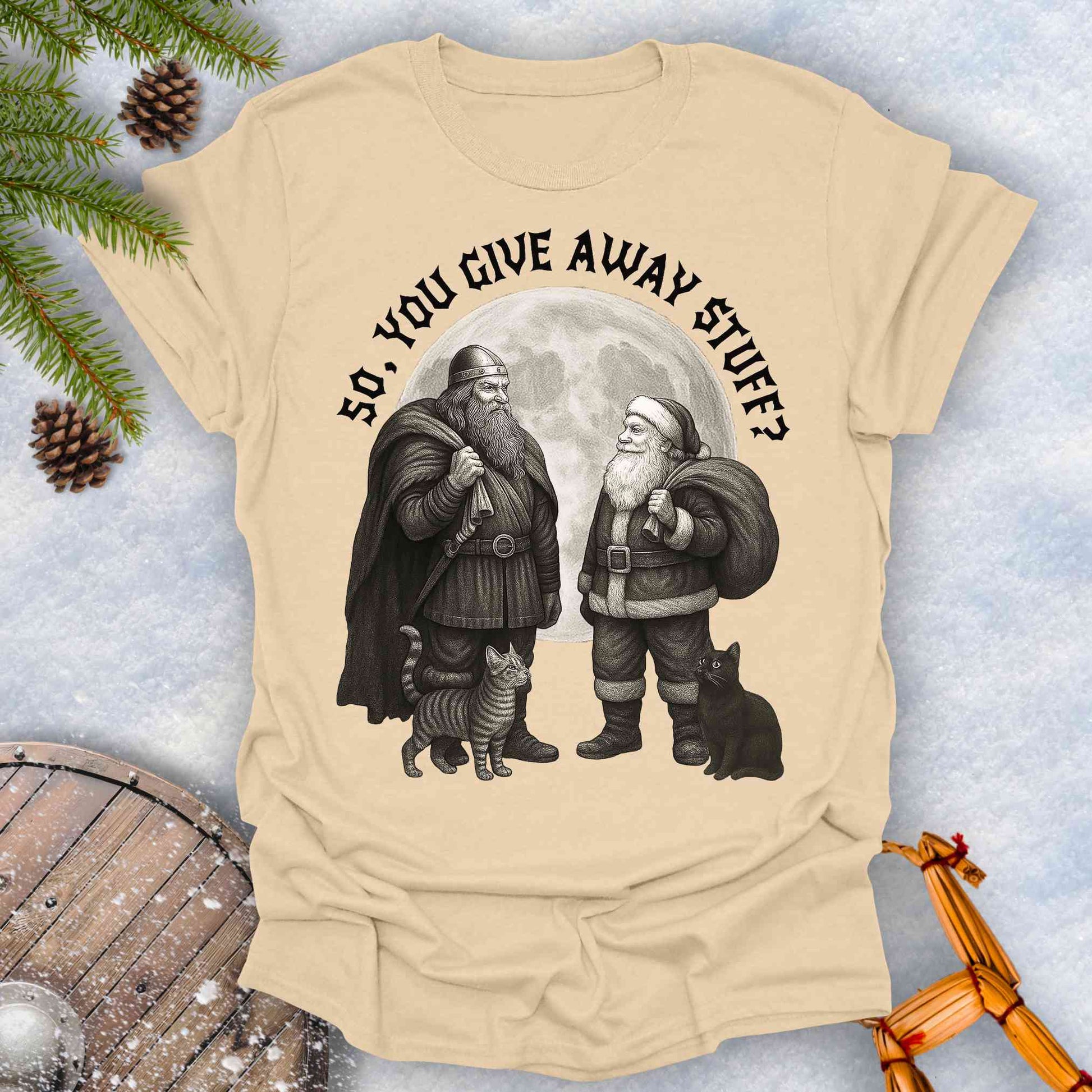 Beige Sand colored t-shirt with graphic of a Viking and Santa Claus with two cats and text 'So, you give away stuff?'.