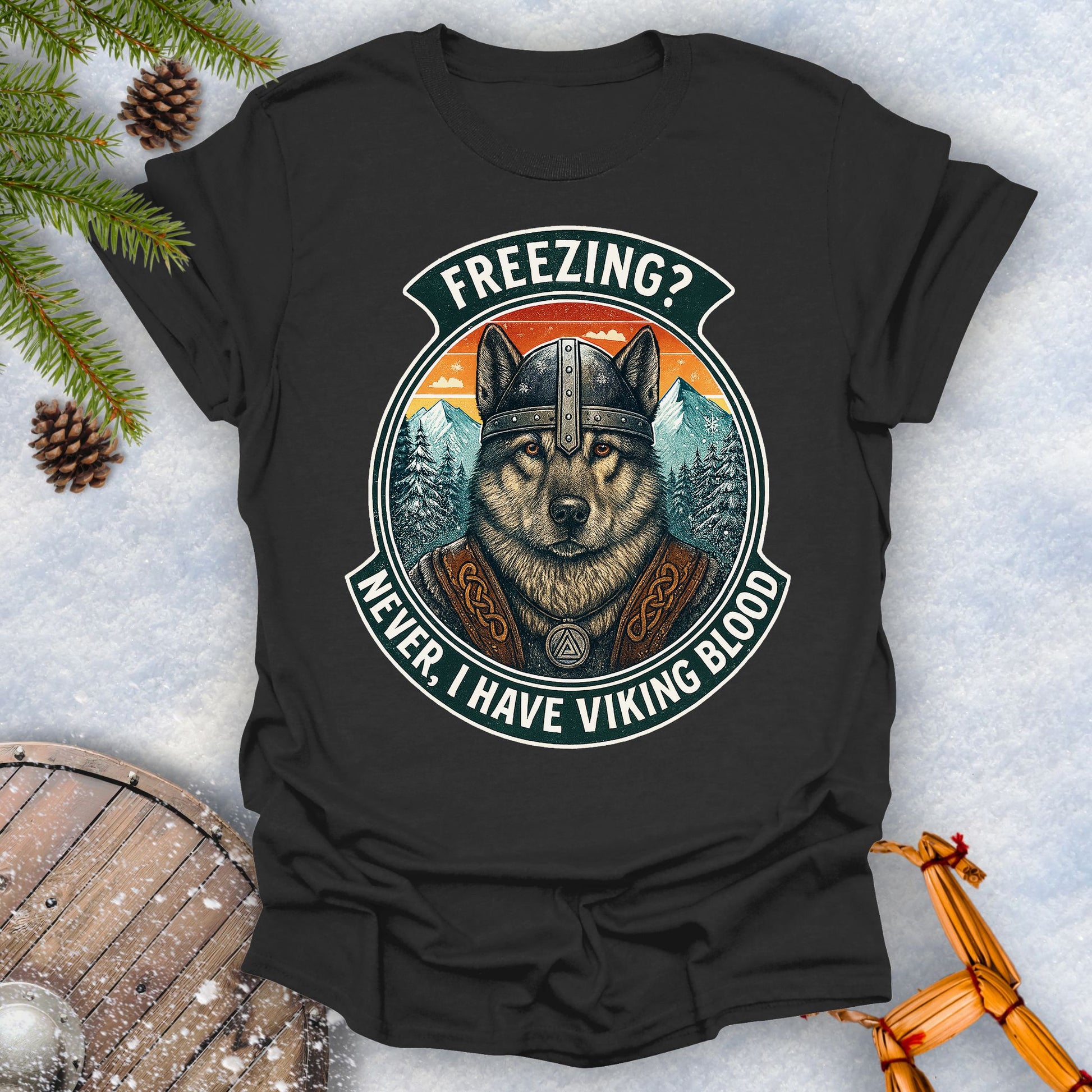 Black t-shirt with a graphic of a Viking Norwegian Elkhound and text 'Freezing? Never, I have Viking blood' with a Nordic, retro sunset graphic in the background.