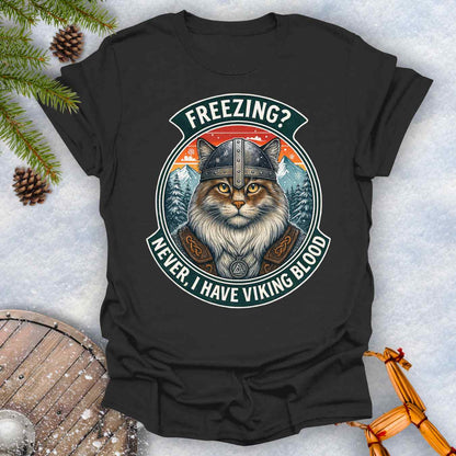 Black T-Shirt with a graphic of a Viking Norwegian Forest Cat and text 'Freezing? Never, I have Viking blood' with a Nordic, retro sunset graphic in the background.
