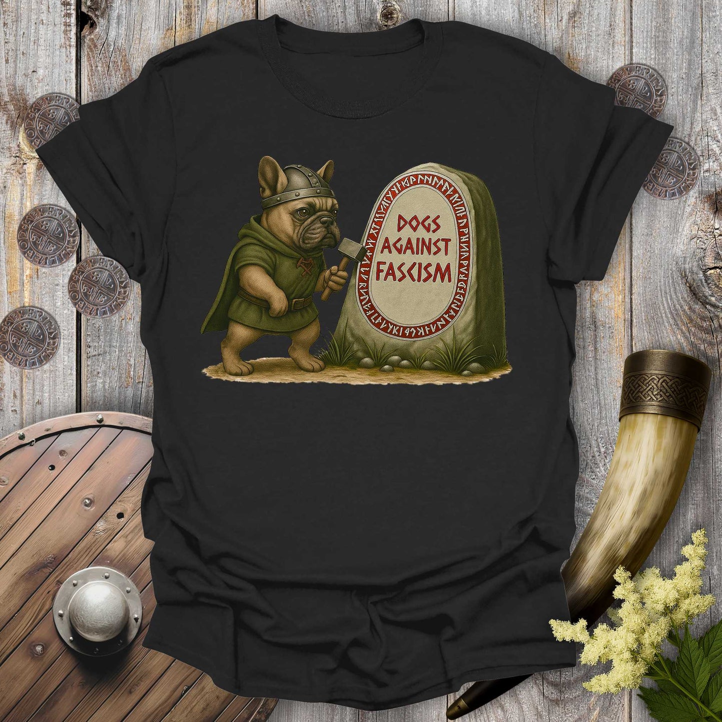Black Anti-Fascism No Kings t-shirt with a graphic of a Bulldog in Viking attire holding a hammer next to a stone with "Dogs Against Fascism" text, displayed on a wooden surface.