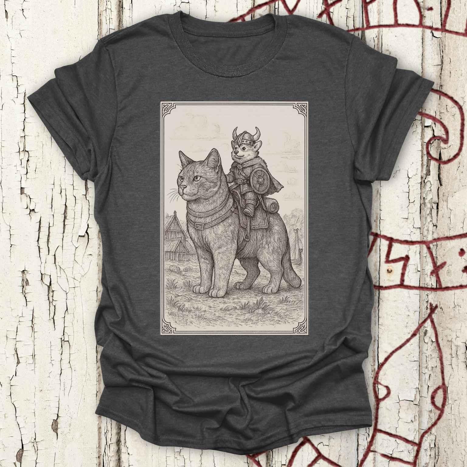 A dark heather gray t-shirt featuring a detailed black and white sketch print of a cat wearing medieval armor with a horned helmet and a Viking corgi dog riding on its back.