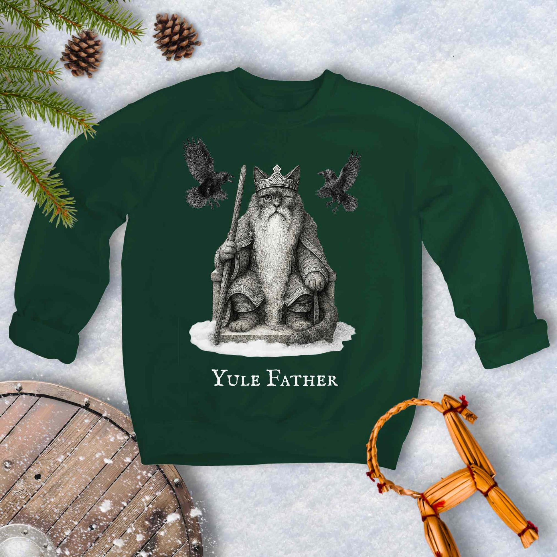 Green sweatshirt with the aesir Odin reimagined as a black cat. Text 'Yule Father' design on a snowy background.