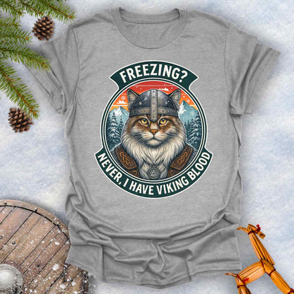 Gray Sports grey T-Shirt with a graphic of a Viking Norwegian Forest Cat and text 'Freezing? Never, I have Viking blood' with a Nordic, retro sunset graphic in the background.