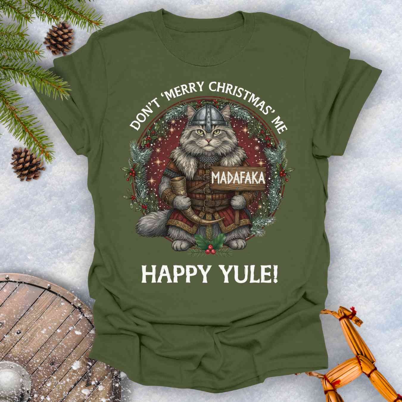 Green t-shirt with a Viking cat Christmas graphic and Christmas-themed text Don't Merry Christmas Me Madafaka, Happy Yule.