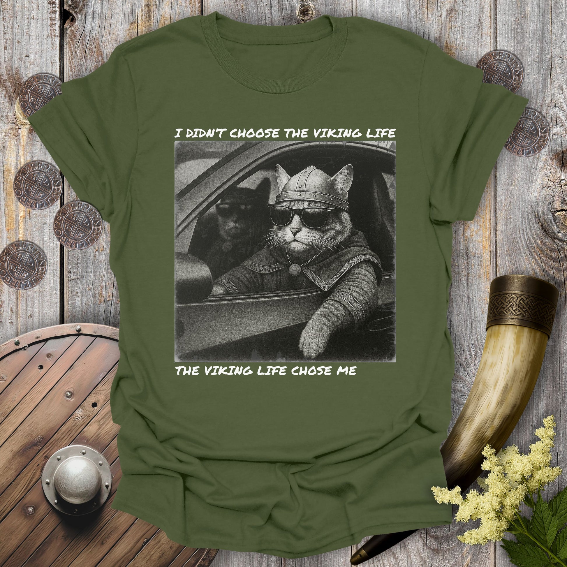Green t-shirt with a graphic of two Viking cats sitting in a car. Text: I Didn't Choose the Viking Life, the Viking Life Chose Me".