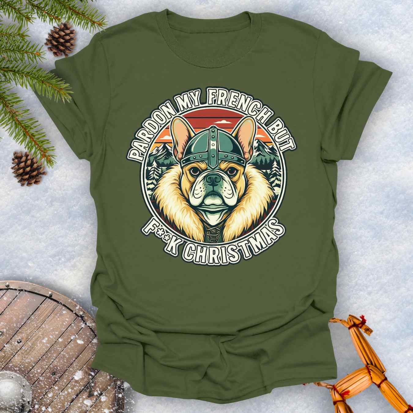 Military Green t-shirt with a graphic of a Viking French bulldog wearing a helmet and Norse winter retro sunset in the background. Text "Pardon My French but F**K Christmas".