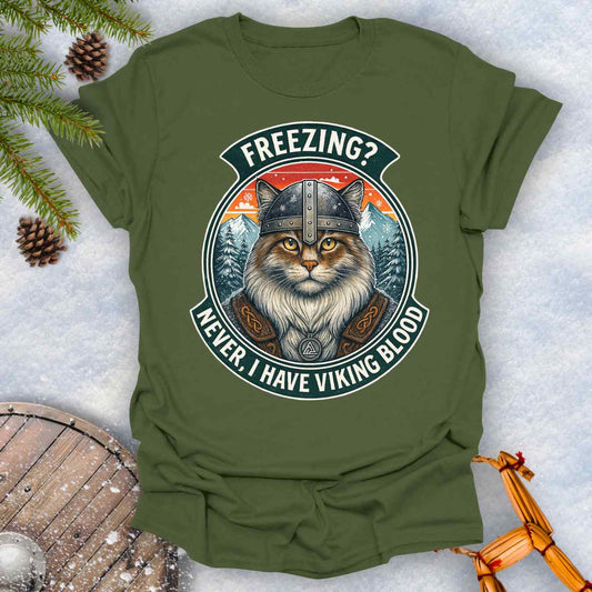 Military Green T-Shirt with a graphic of a Viking Norwegian Forest Cat and text 'Freezing? Never, I have Viking blood' with a Nordic, retro sunset graphic in the background.