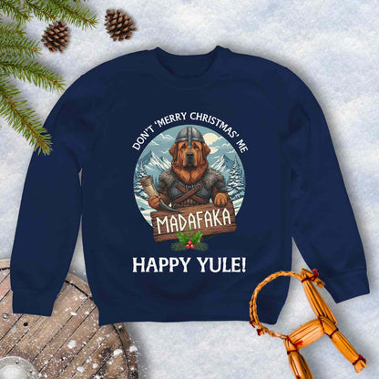 Navy Blue sweatshirt with a Viking Tibetan Mastiff holding a sign that says MADAFAKA. Also text: Don´t Merry Christmas Me, Happy Yule! Snowy Mountains and trees in the background.