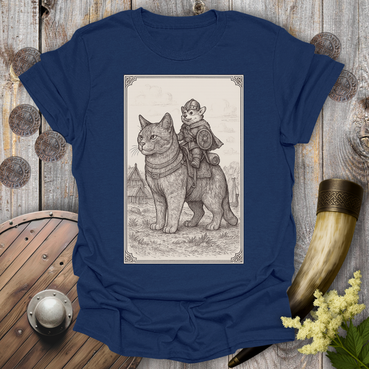 Navy Blue t-shirt with a beige and black graphic of a large cat and a Corgi Viking Dog riding it, in a Medieval Viking Age setting. 