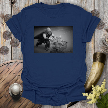 Navy Blue t-shirt with a graphic of a Viking and a cat in a shopping cart, sprinting on a parking lot.
