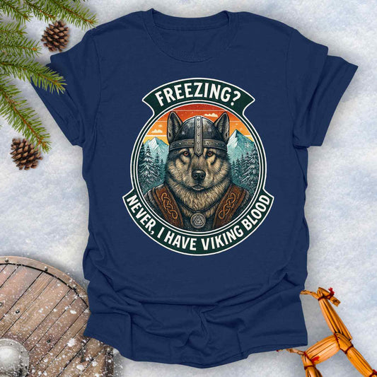 Navy blue t-shirt with a graphic of a Viking Norwegian Elkhound and text 'Freezing? Never, I have Viking blood' with a Nordic, retro sunset graphic in the background.