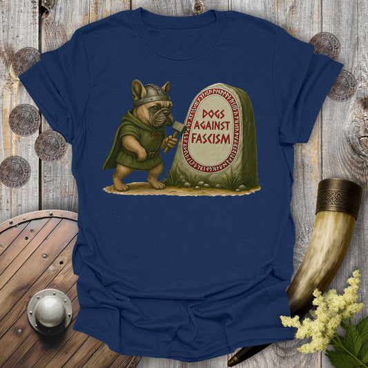 Navy Blue Anti-Fascism No Kings t-shirt with a graphic of a Bulldog in Viking attire holding a hammer next to a stone with "Dogs Against Fascism" text, displayed on a wooden surface.