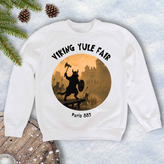 White sweatshirt with Viking cat design and white 'Viking Yule Fair' and 'Paris 885’ text on a snowy background.