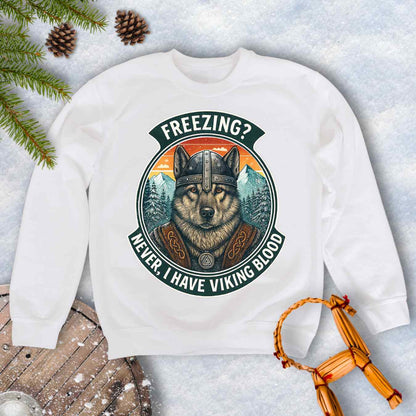 White sweatshirt with a graphic of a Viking Norwegian Elkhound and text 'Freezing? Never, I have Viking blood' with a Nordic, retro sunset graphic in the background.