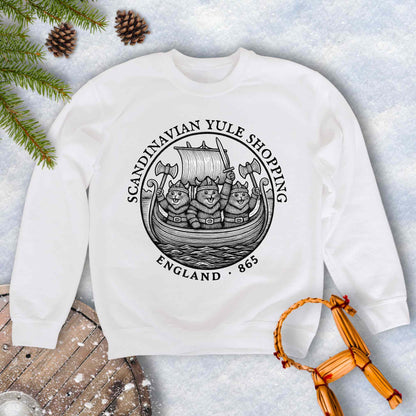 White sweatshirt with black and white design with Viking Cats on a Viking ship and text Scandinavian Yule Shopping, England 865.