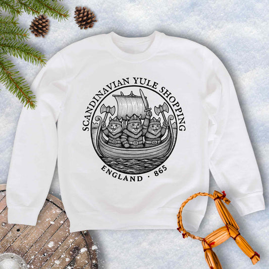 White sweatshirt with black and white design with Viking Cats on a Viking ship and text Scandinavian Yule Shopping, England 865.
