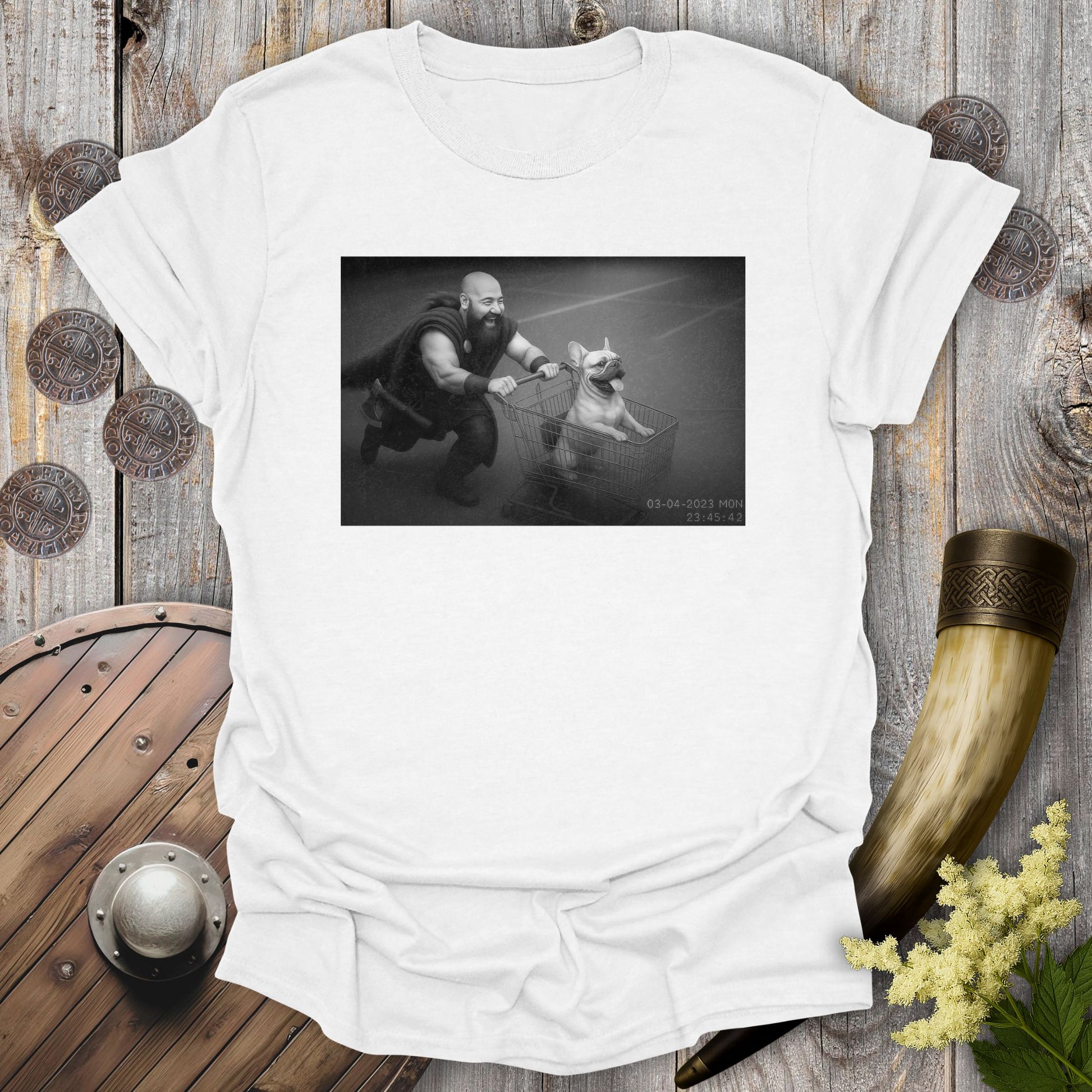 White t-shirt with a graphic of a Viking and a Bulldog in a shopping cart, sprinting on a parking Lot.